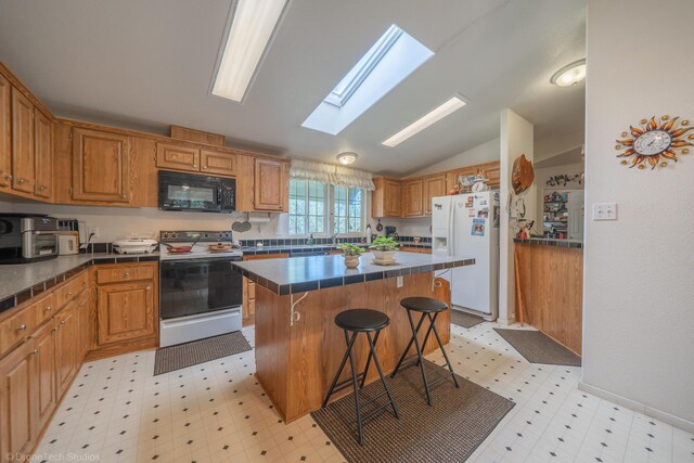 kitchen with a center island, lofted ceiling with skylight, white refrigerator with ice dispenser, electric range oven, and a kitchen breakfast bar