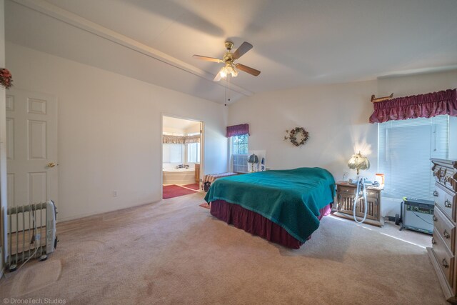 carpeted bedroom featuring lofted ceiling, connected bathroom, and ceiling fan