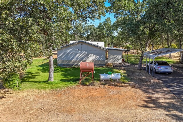 view of front facade featuring a carport and a front yard