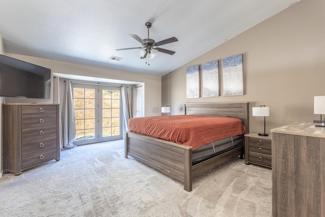 bedroom with light carpet, access to outside, vaulted ceiling, and visible vents