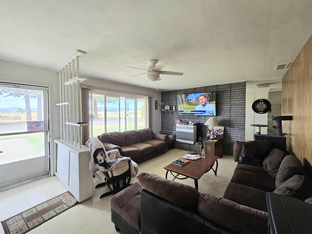 living room featuring visible vents, ceiling fan, and light floors