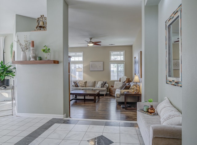 living room featuring ceiling fan and light hardwood / wood-style floors