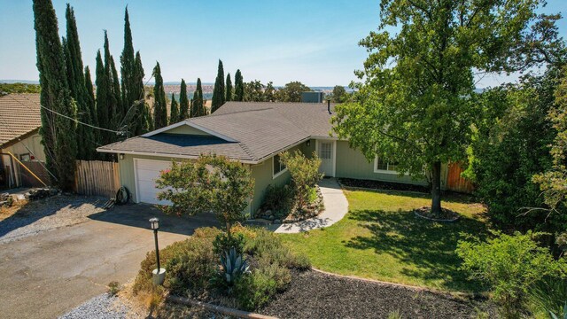 ranch-style home featuring a front lawn and a garage