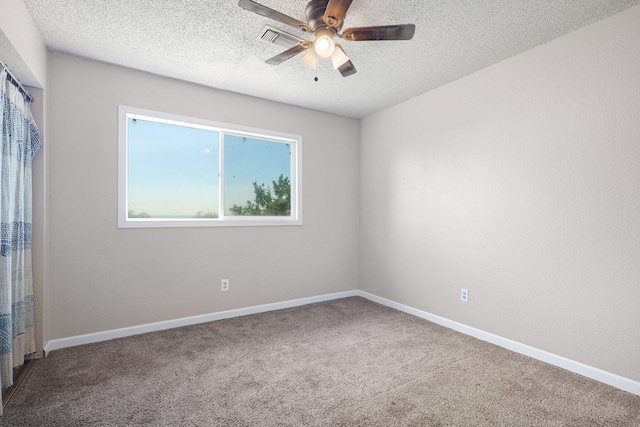 carpeted empty room with a textured ceiling and ceiling fan