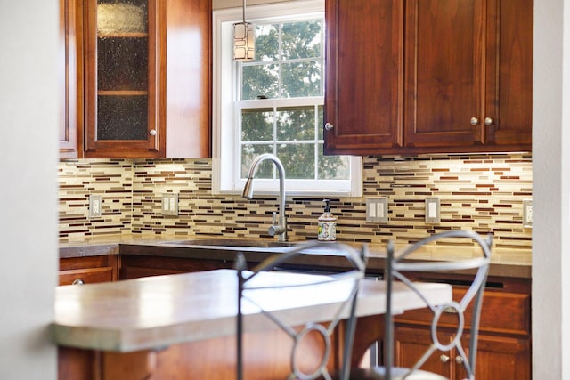 kitchen featuring a healthy amount of sunlight, pendant lighting, and decorative backsplash