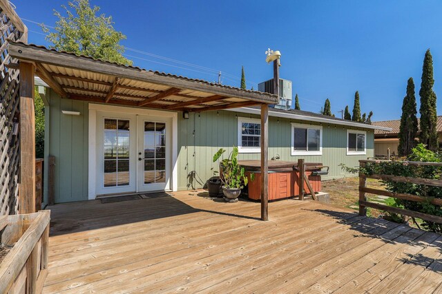 wooden deck featuring french doors, a hot tub, and central AC