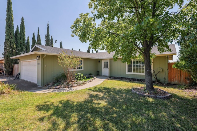 ranch-style house featuring a front yard and a garage