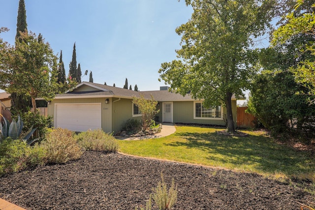 ranch-style home with a front lawn and a garage