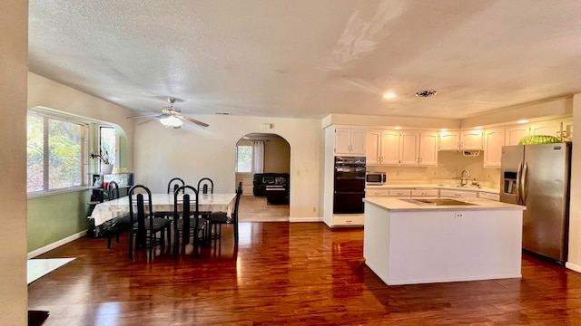 kitchen featuring dark hardwood / wood-style floors, black appliances, sink, white cabinetry, and ceiling fan