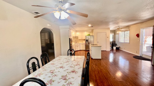 dining room with a textured ceiling, ceiling fan, dark hardwood / wood-style floors, and sink