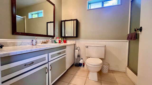 bathroom featuring a shower with shower door, toilet, a wealth of natural light, and vanity