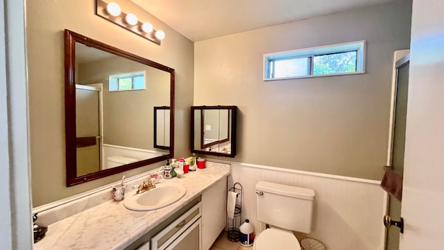 bathroom featuring toilet, a shower with door, and vanity