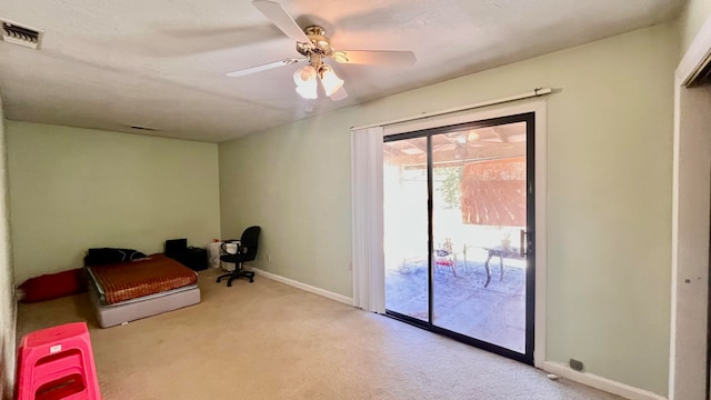 interior space with light colored carpet, access to exterior, and ceiling fan