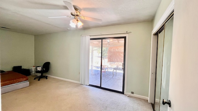 interior space with a textured ceiling, ceiling fan, light carpet, and access to outside