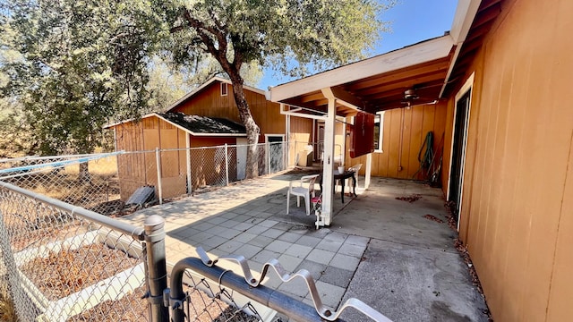 view of patio / terrace featuring ceiling fan and a storage unit