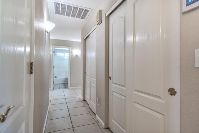 hall with light tile patterned flooring