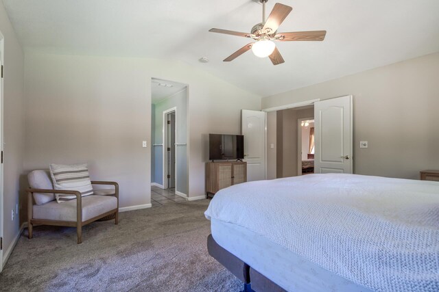 carpeted bedroom featuring ceiling fan and vaulted ceiling