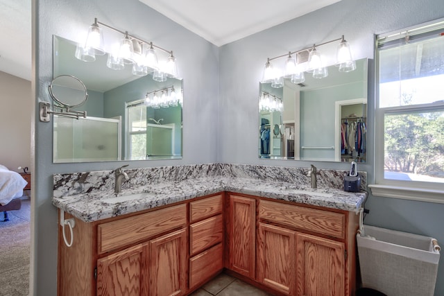 bathroom featuring crown molding, vanity, tile patterned floors, and a shower with door