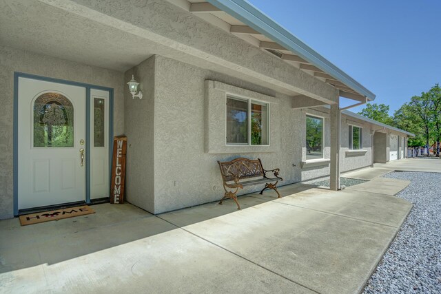 property entrance featuring a patio area