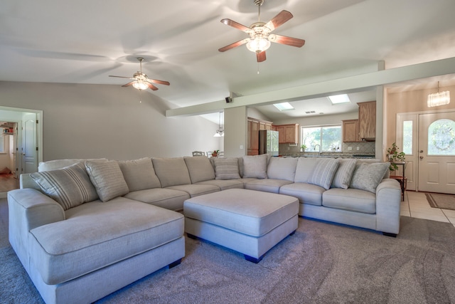 tiled living room with lofted ceiling and ceiling fan