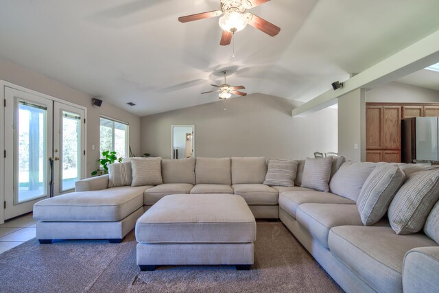 living room with lofted ceiling, ceiling fan, and tile patterned flooring