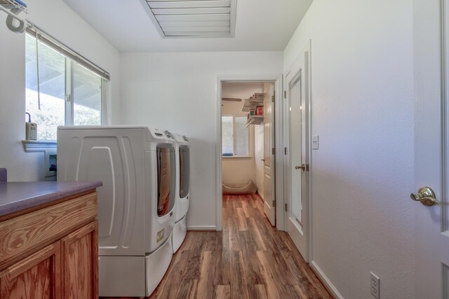 washroom with dark wood-type flooring and washer and clothes dryer