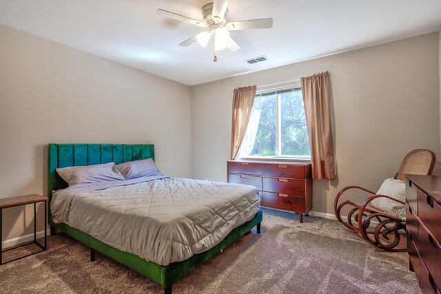 bedroom with dark colored carpet and ceiling fan