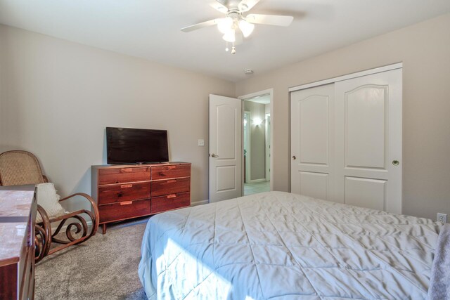 carpeted bedroom featuring a closet and ceiling fan