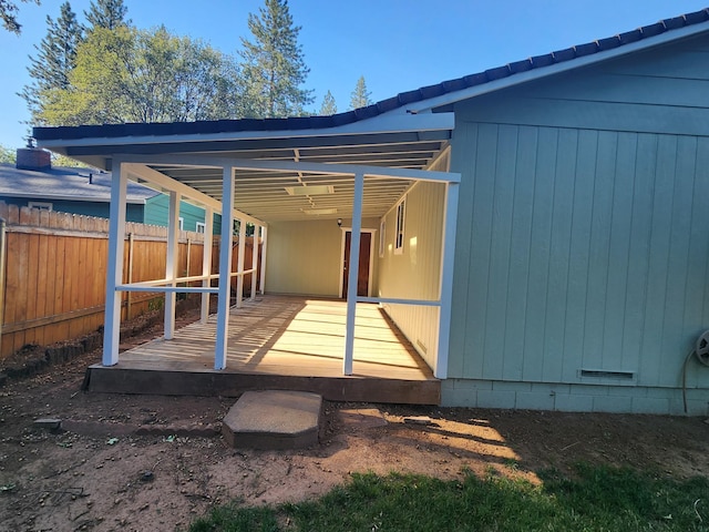 back of house featuring a wooden deck