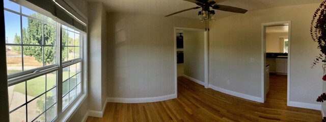 spare room featuring hardwood / wood-style flooring and ceiling fan