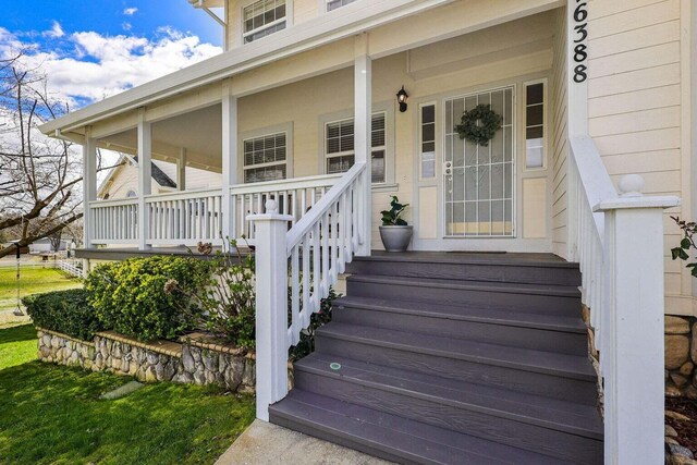 entrance to property featuring a porch