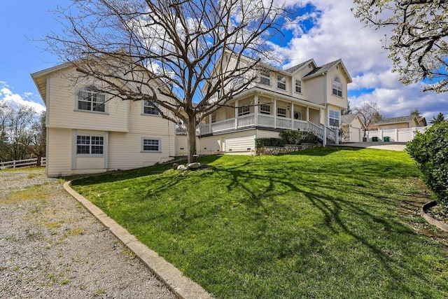 rear view of property with a yard and covered porch