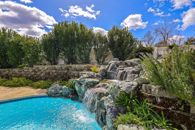 view of pool with pool water feature