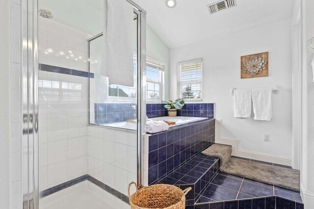 bathroom with lofted ceiling, separate shower and tub, and tile patterned flooring