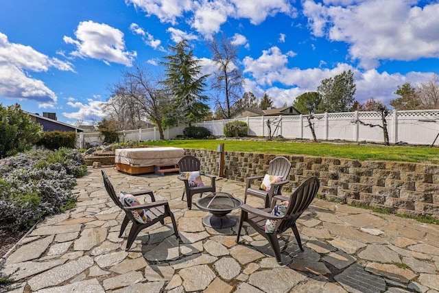 view of patio featuring an outdoor fire pit and a hot tub