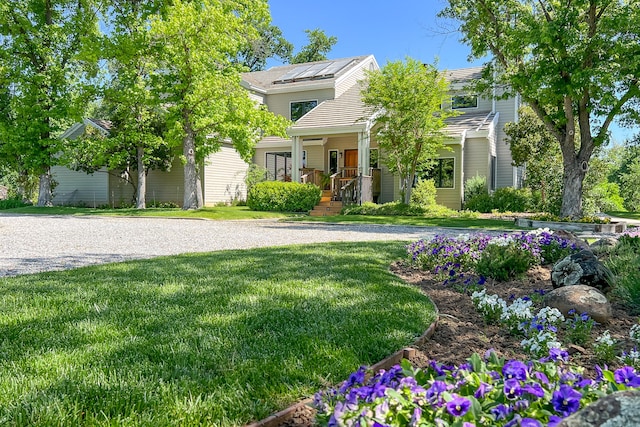 obstructed view of property featuring a porch and a front lawn