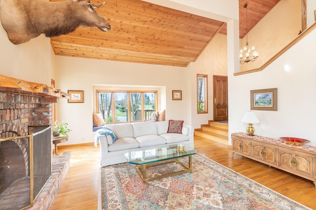 living room with light wood-type flooring, high vaulted ceiling, and a fireplace