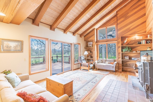 living room with plenty of natural light, beam ceiling, wooden ceiling, and light hardwood / wood-style floors