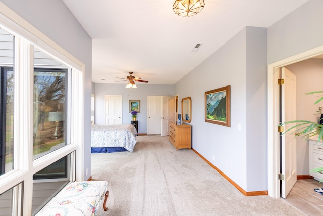 bedroom featuring ceiling fan and light carpet