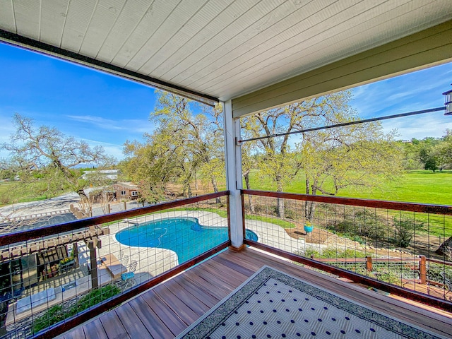 deck featuring a fenced in pool