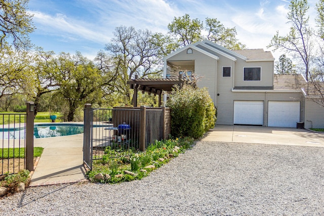 view of side of property featuring a garage and a fenced in pool