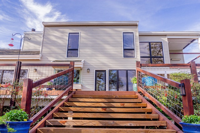 back of house with a wooden deck