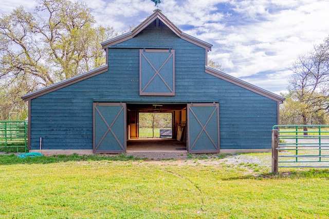 back of property with a lawn and an outdoor structure