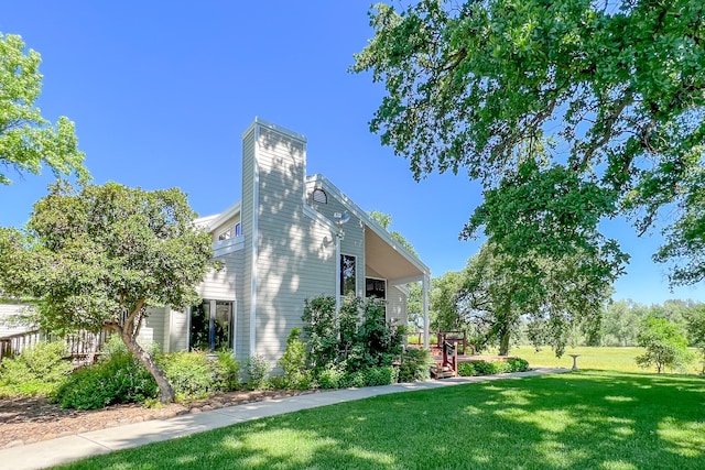 view of side of property with a lawn