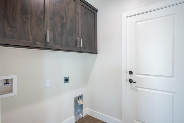 washroom featuring cabinets, electric dryer hookup, hookup for a washing machine, and dark hardwood / wood-style floors