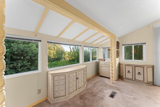 sunroom with vaulted ceiling with beams