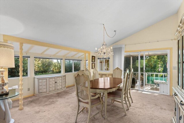 carpeted dining room with lofted ceiling and a chandelier