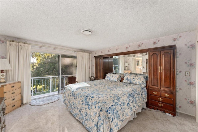 bedroom featuring multiple windows, light carpet, and a textured ceiling