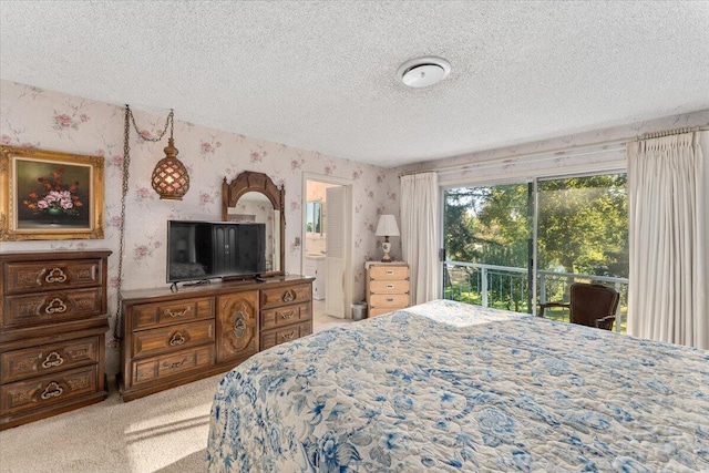 carpeted bedroom featuring access to outside and a textured ceiling