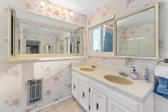 bathroom with walk in shower and vanity